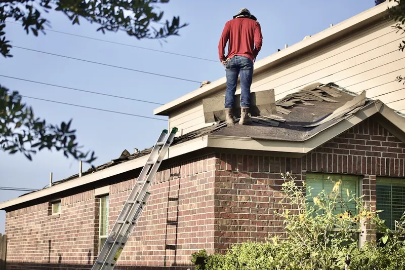 Professional roofer working on a residential roof in Brockroad